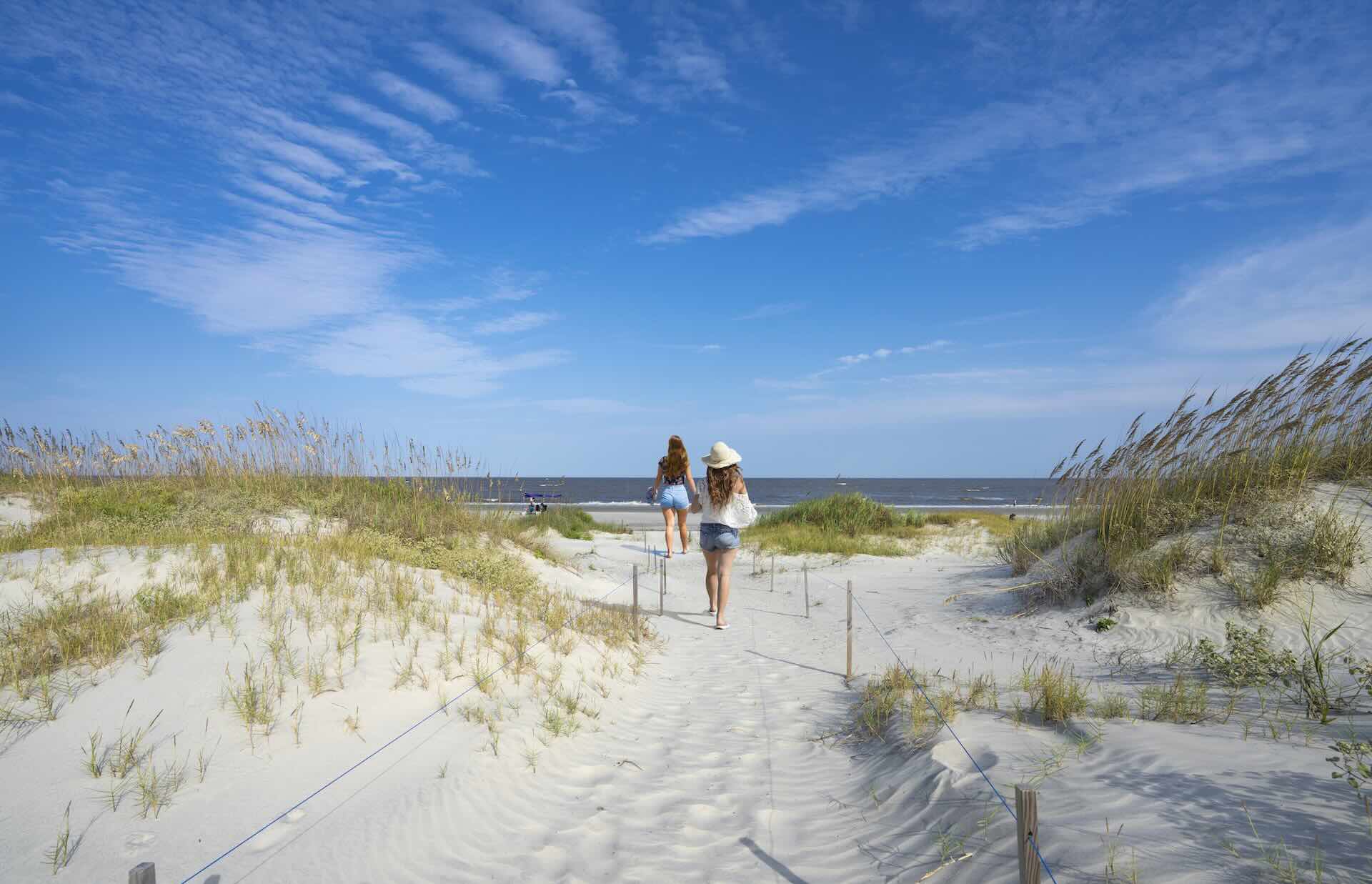 Photo of girls walking to the ocean of Georgia Golden Isles